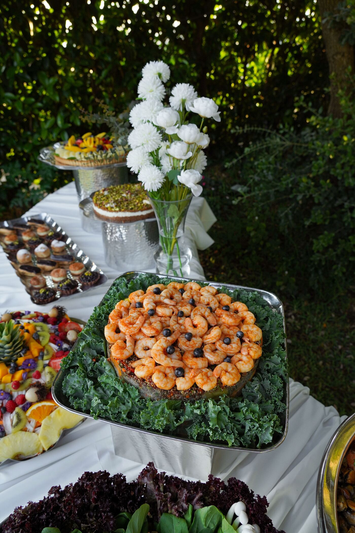 Paprika shrimp over quinoa, ringed with kale on a silver platter